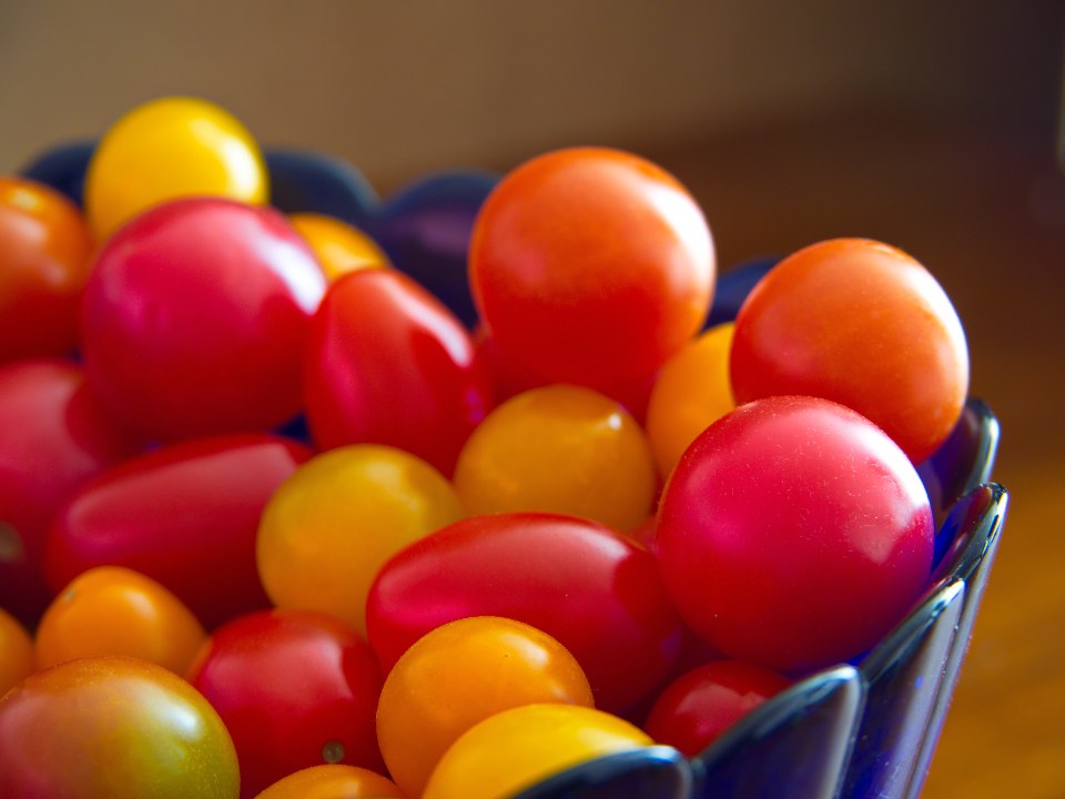 A bowl of colorful cherry tomatoes in red, orange and yellow